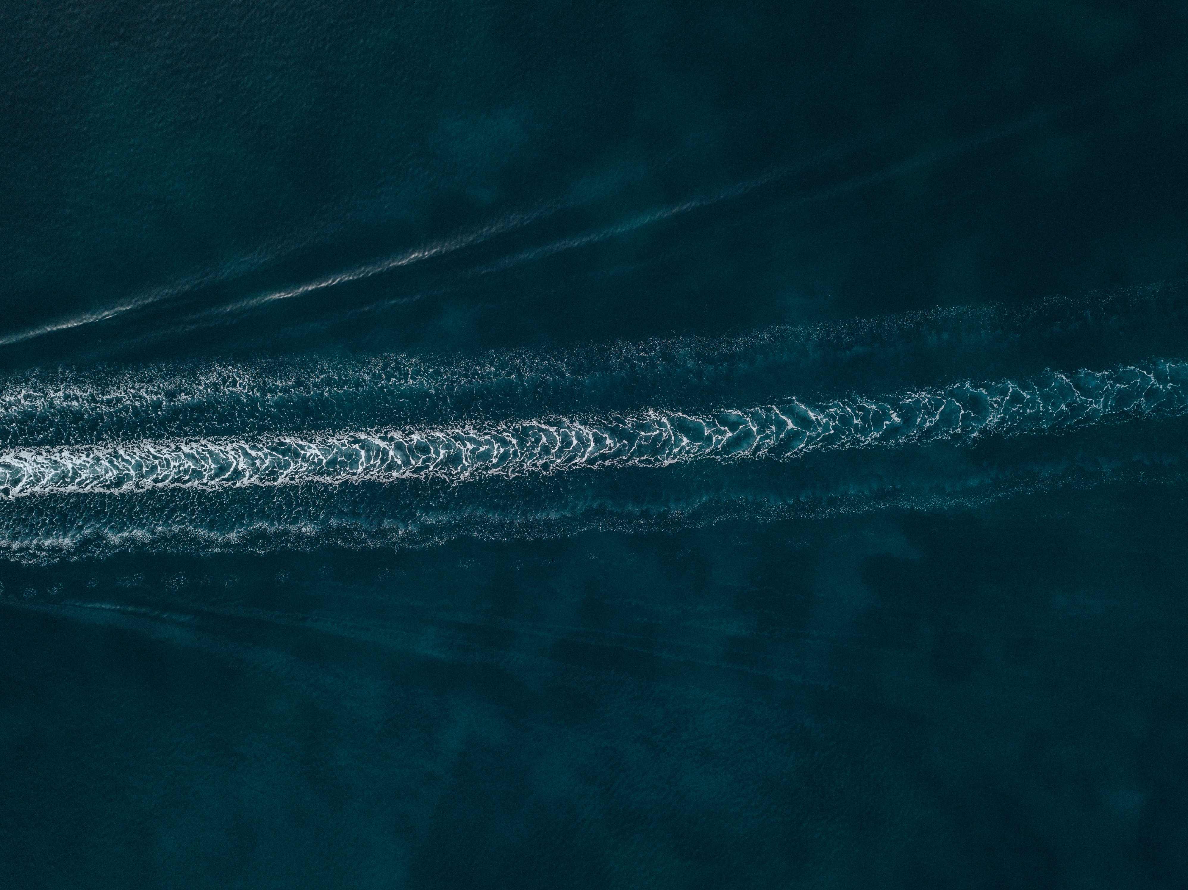 Boatr.ai - Aerial view of water trails on beautiful blue sea